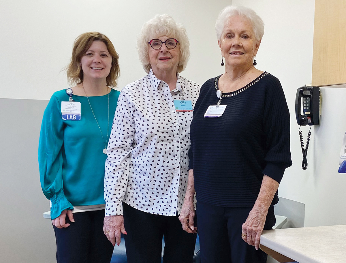 laboratory director Jackie Skaer and Auxiliary representatives Joyce Barton and Lois Wright, RN.